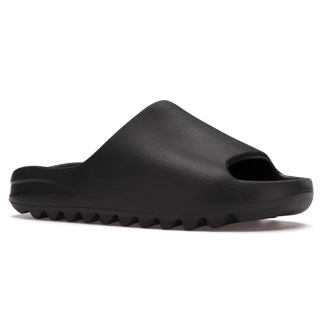 Yeezy Slides Onyx in all-black EVA foam design, offering comfort and minimalist style.