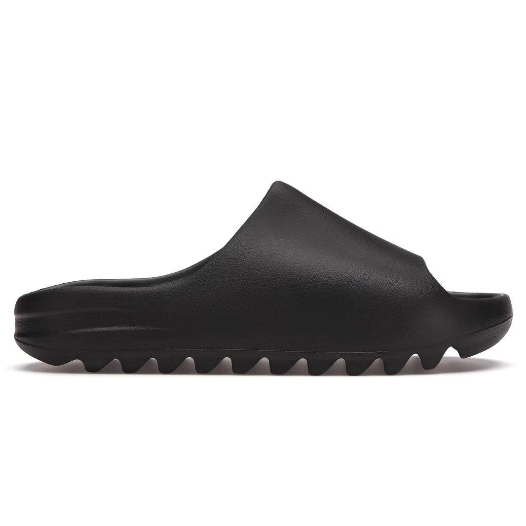 Yeezy Slides Onyx all-black design with textured footbed and durable outsole.