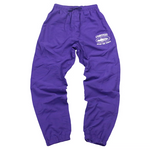 Corteiz Shukushuku Track Pants in grape purple.