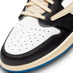 Air Jordan 1 Retro Low x Travis Scott Fragment sneaker, featuring white leather, black suede overlays, and blue accents.