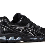 Black and silver Gel Kayano 14 running shoe with cushioning and mesh upper design