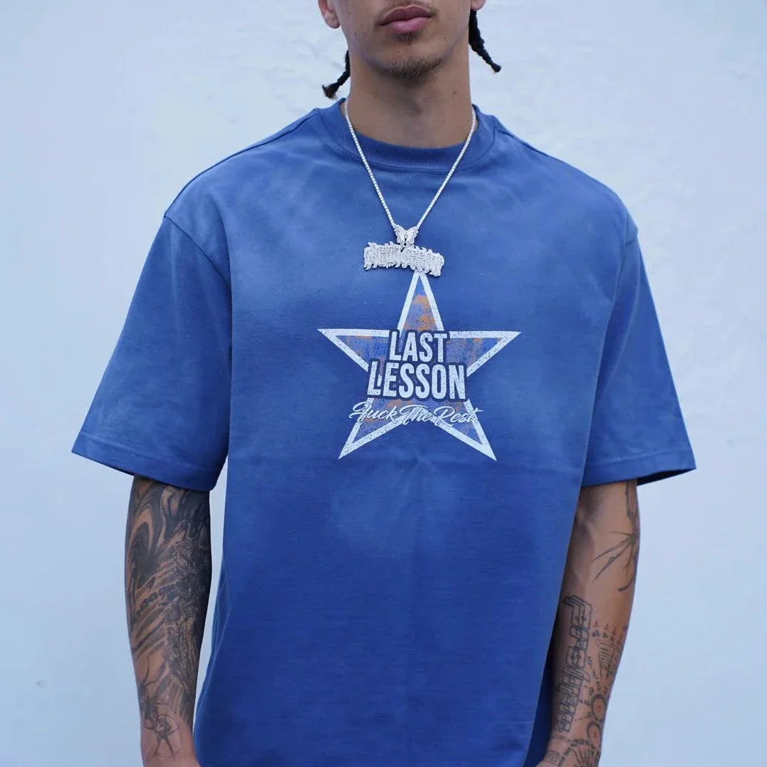 man wearing Last Lesson Blue Washed Star T-shirt in wash blue with star graphic