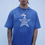 man wearing Last Lesson Blue Washed Star T-shirt in wash blue with star graphic
