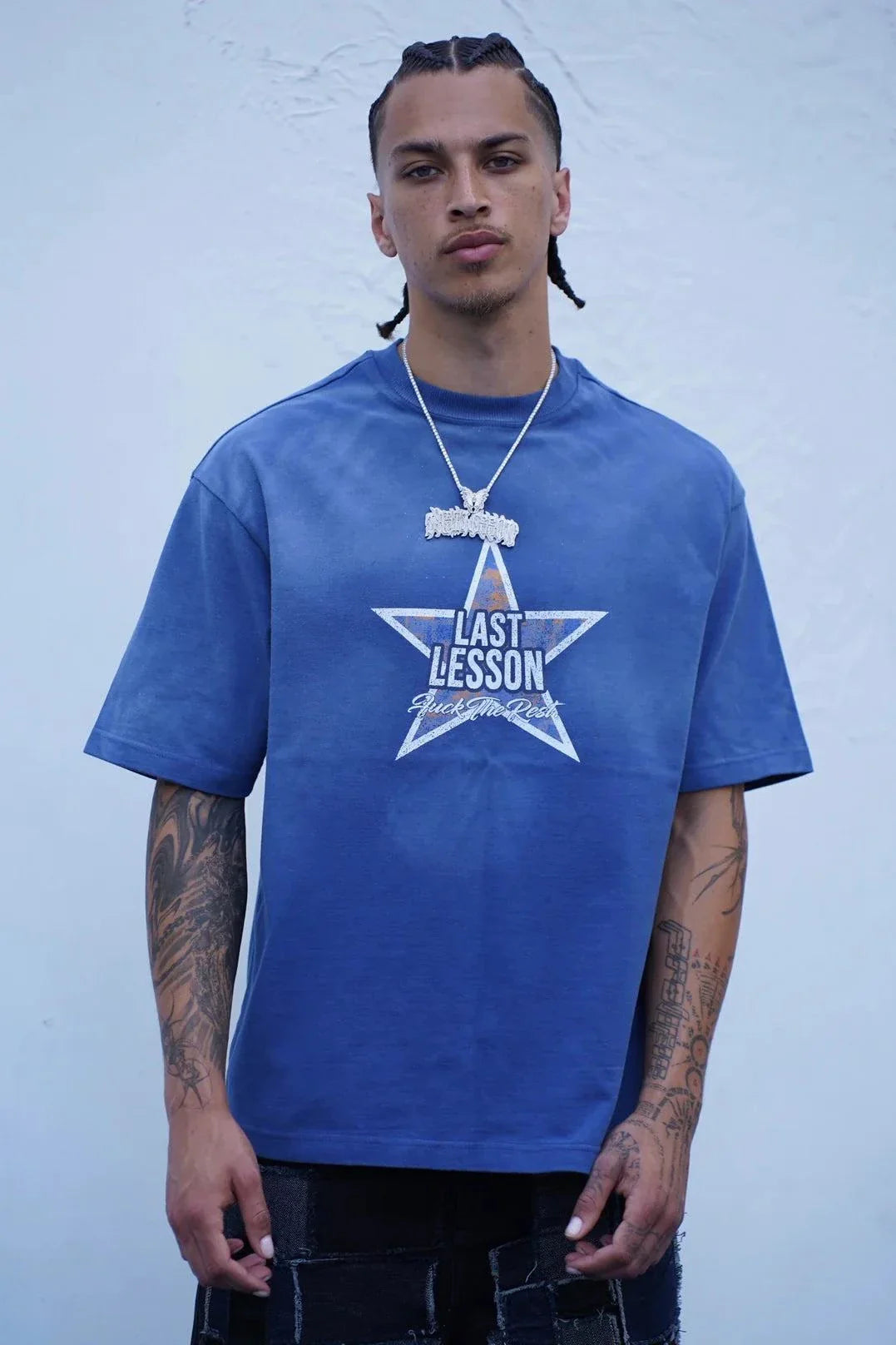 man wearing Last Lesson Blue Washed Star T-shirt in wash blue with star graphic