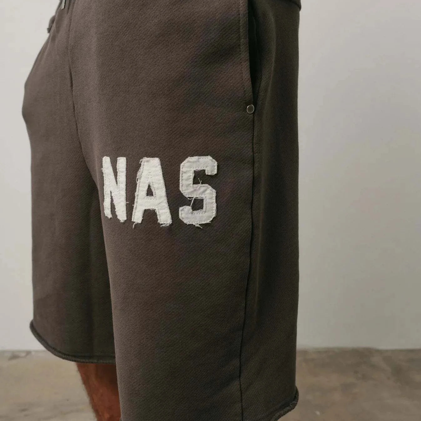 Brown Natural Art Studio NAS appliqué cotton shorts with elastic waistband and metal rivets on pockets