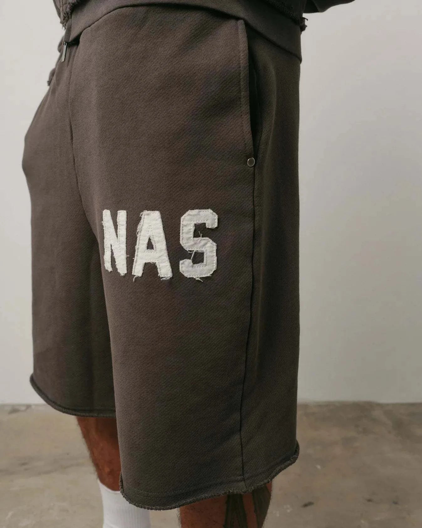 Brown Natural Art Studio NAS appliqué cotton shorts with elastic waistband and metal rivets on pockets