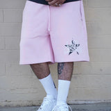 Pink Last Lesson All-Star Shorts worn with white sneakers.