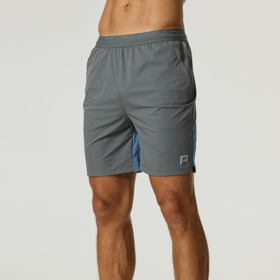 Reprimo Flight Shorts in Air Force Blue and Gunmetal with breathable fabric, elastic waistband, functional zippered pockets, and 18cm inseam for optimal movement and comfort.