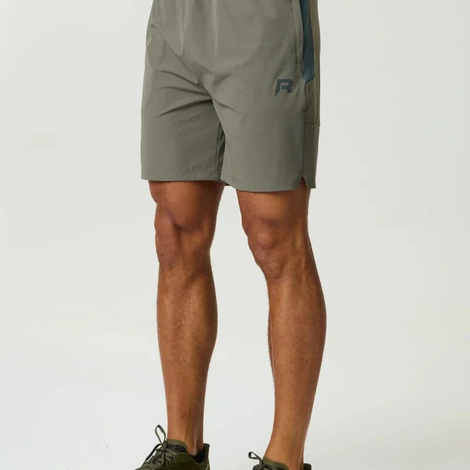 Reprimo Vortex Shorts in dark moss and grey velvet with ergonomic paneling and adjustable waistband for performance and style