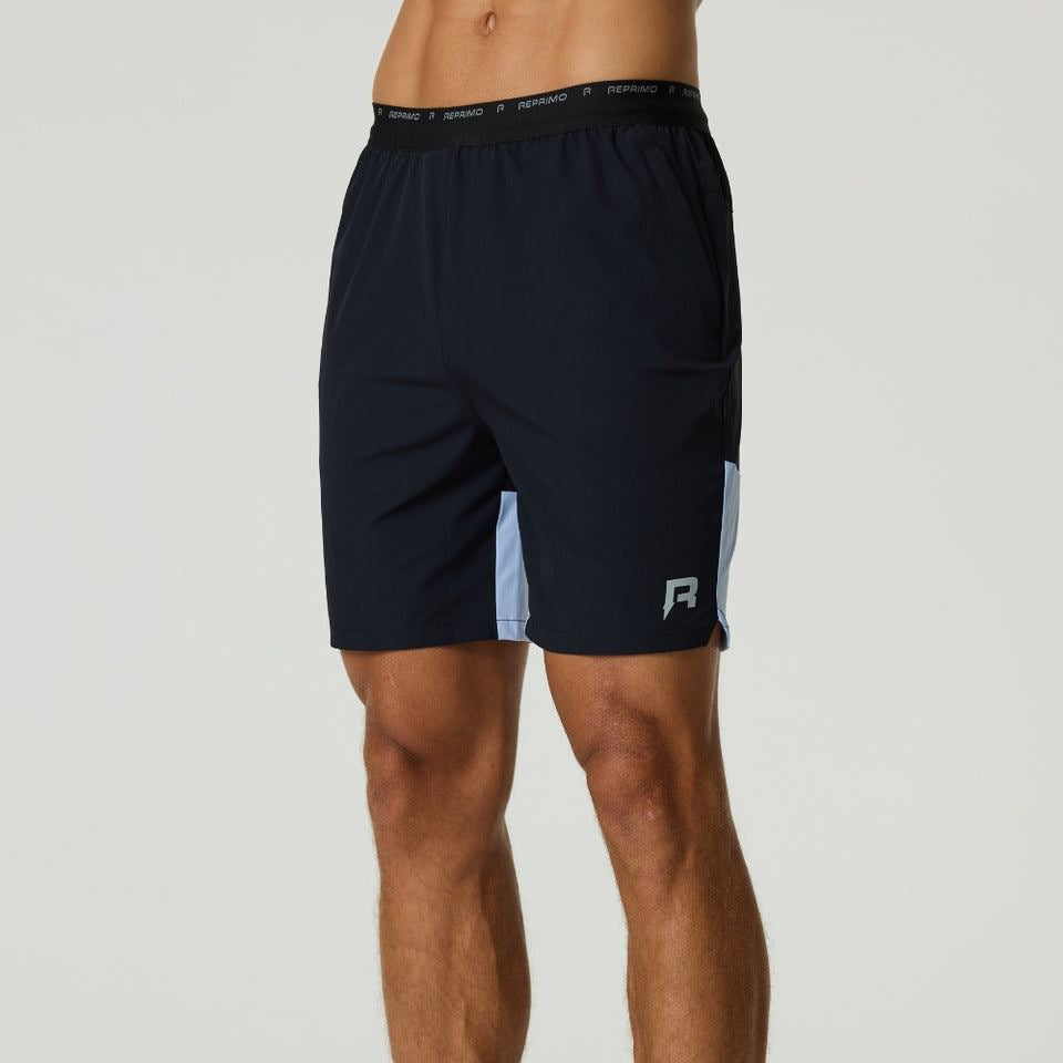Reprimo Flight Shorts in black with dusky sky panels, lightweight breathable fabric, elastic waistband, and tonal zippered pockets for active performance.