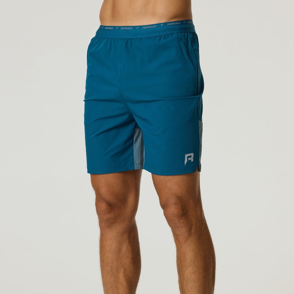 Reprimo Flight Shorts in tidal teal with breathable fabric, elastic waistband, and functional zippered pockets for active performance.
