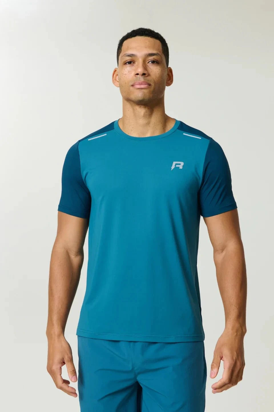 Reprimo Flight T-Shirt in lake blue and teal with breathable fabric and reflective strips for athletic performance