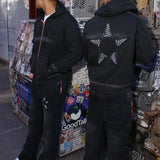 Black hoodie with star appliqué design on back, modeled by two people in an urban setting, Last Lesson Hoodie.