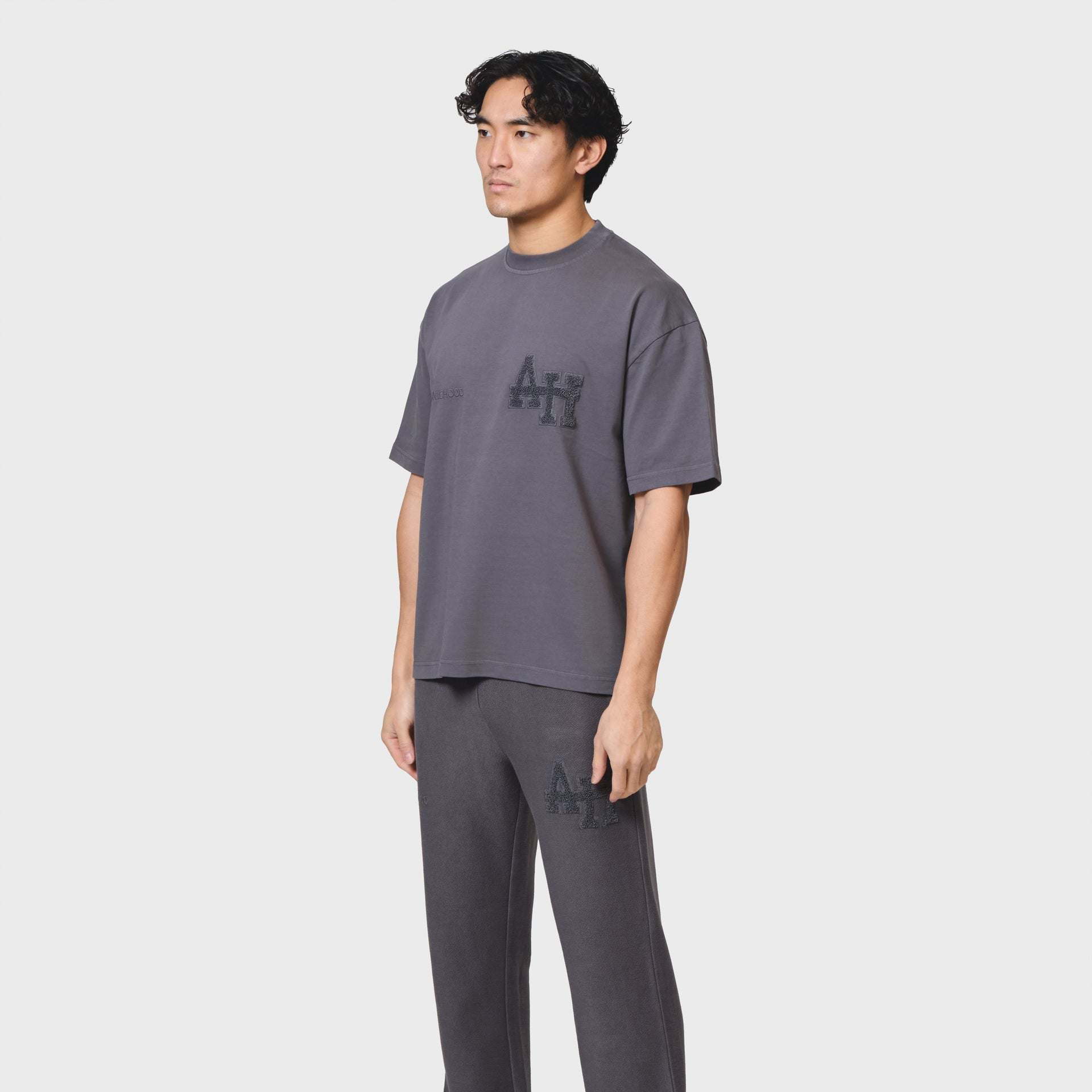 Annie Hood College T-shirt in washed black with 280gsm cotton and relaxed fit worn by a 6'0" model in size M