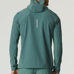 Man wearing botanical pine Reprimo Glide Jacket viewed from the back with hood up
