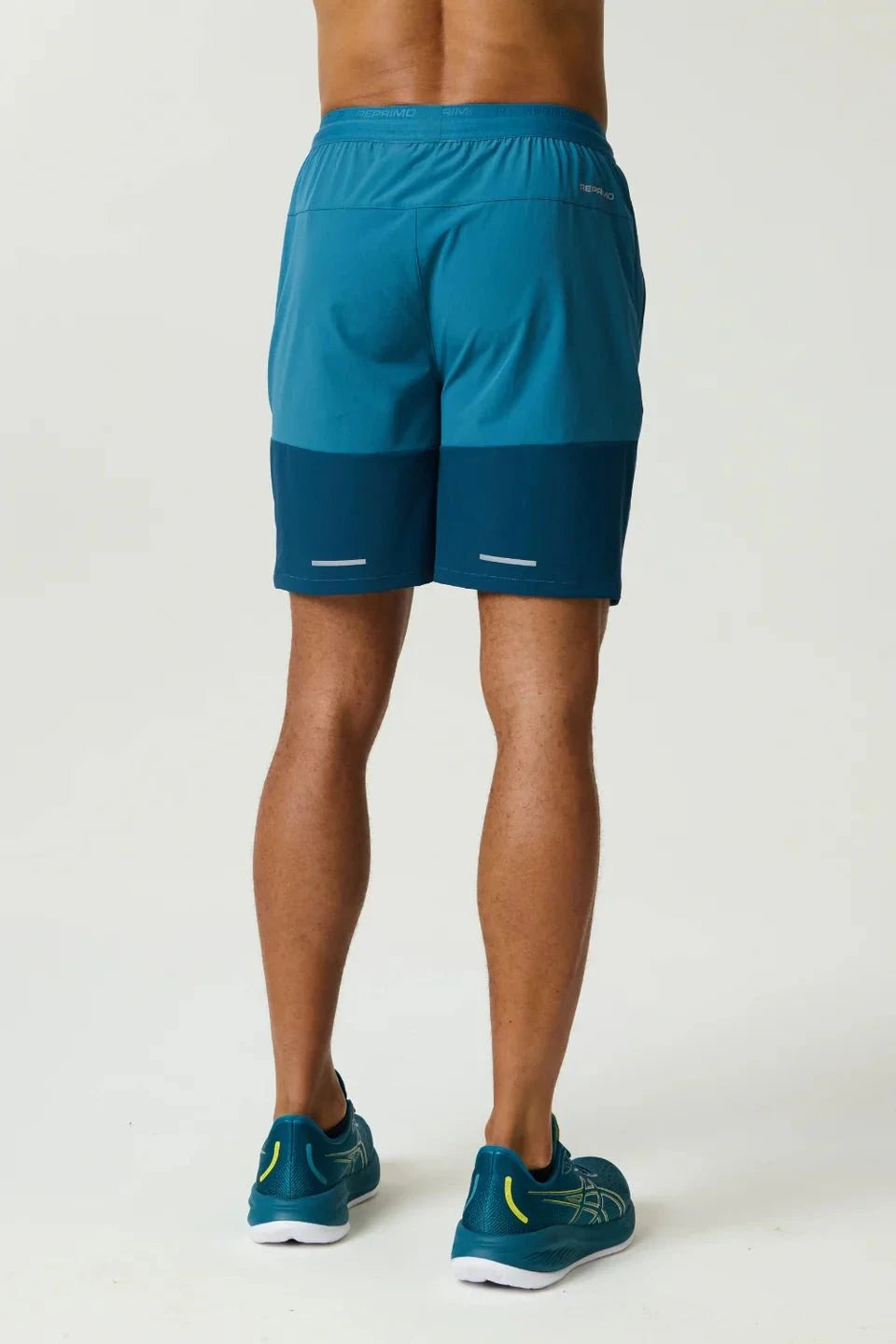 Lake blue Reprimo Flight Shorts with breathable fabric, elastic waistband, and secure zippered pockets for athletic performance and comfort