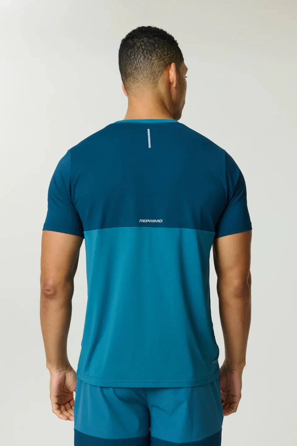 Reprimo Flight T-Shirt in lake blue and teal with breathable fabric and reflective strips for athletic performance