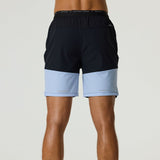 Rear view of a person wearing black and dusky sky Reprimo Flight Shorts with elastic waistband and lightweight breathable fabric.