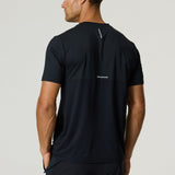 Athlete wearing black Reprimo Flight T-Shirt with reflective strip on back, breathable lightweight athletic fit design