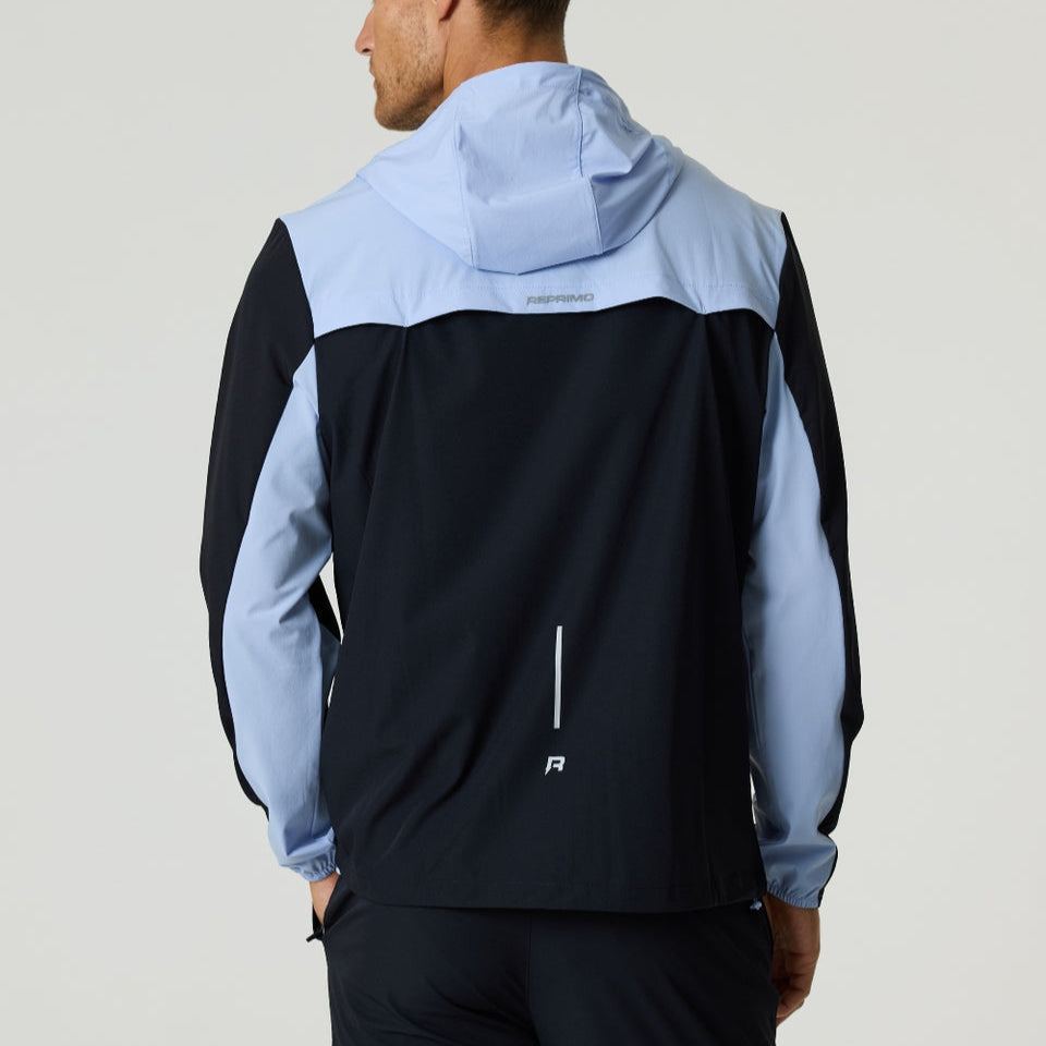 Back view of black and dusky sky Reprimo Flight Windbreaker with hood and zip pockets for lightweight weather protection