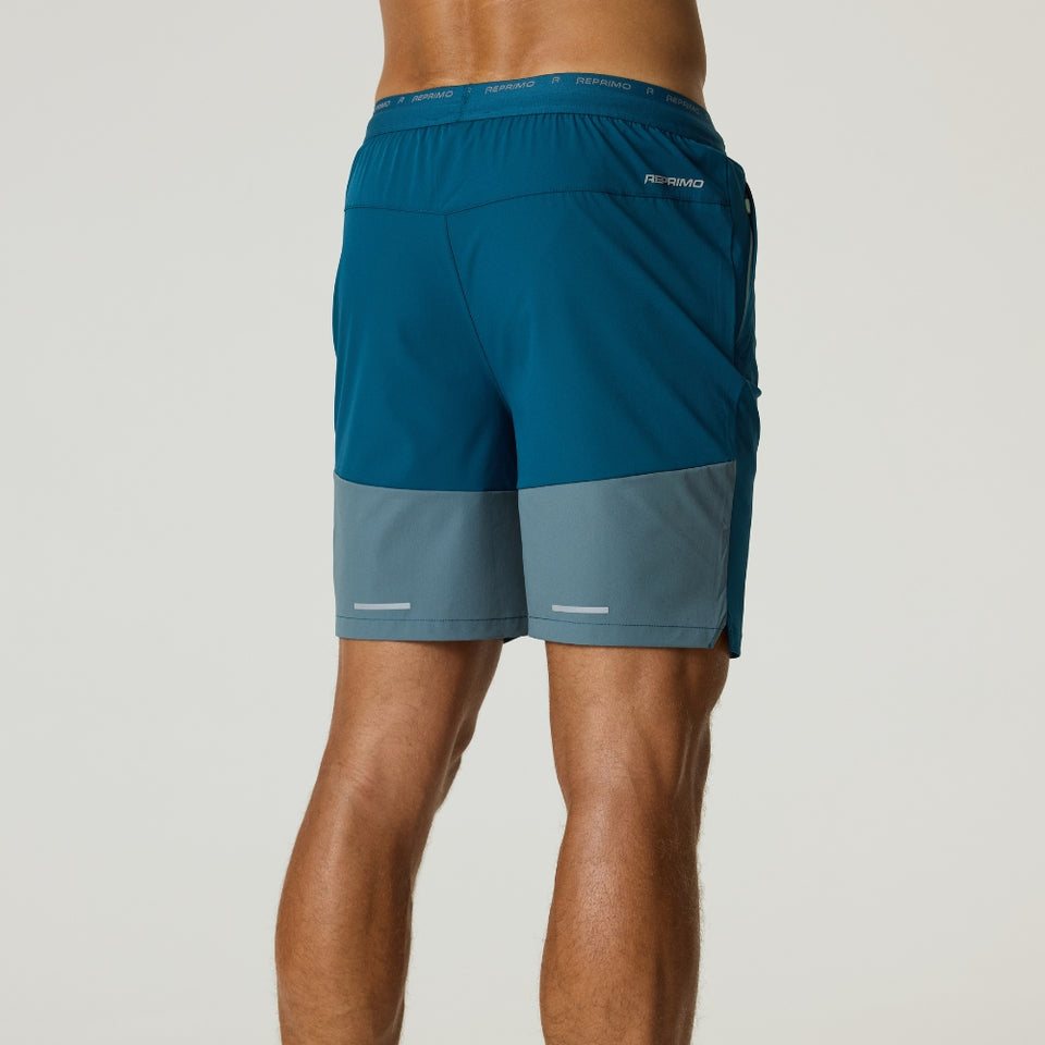 Reprimo Flight Shorts in tidal teal and blue steel with breathable fabric, elastic waistband, and functional side pockets, designed for lightweight performance and freedom of movement.