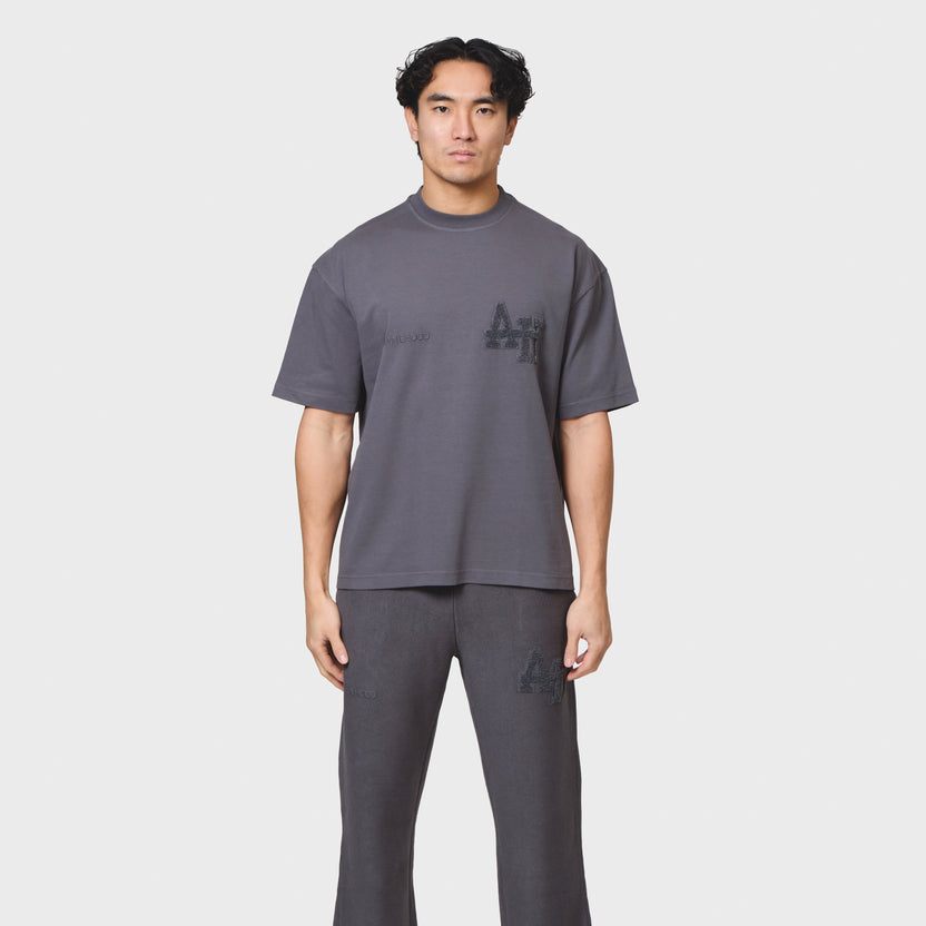 Annie Hood College T-shirt in washed black with relaxed fit, made from 280gsm cotton, worn by a 6'0 model in size M