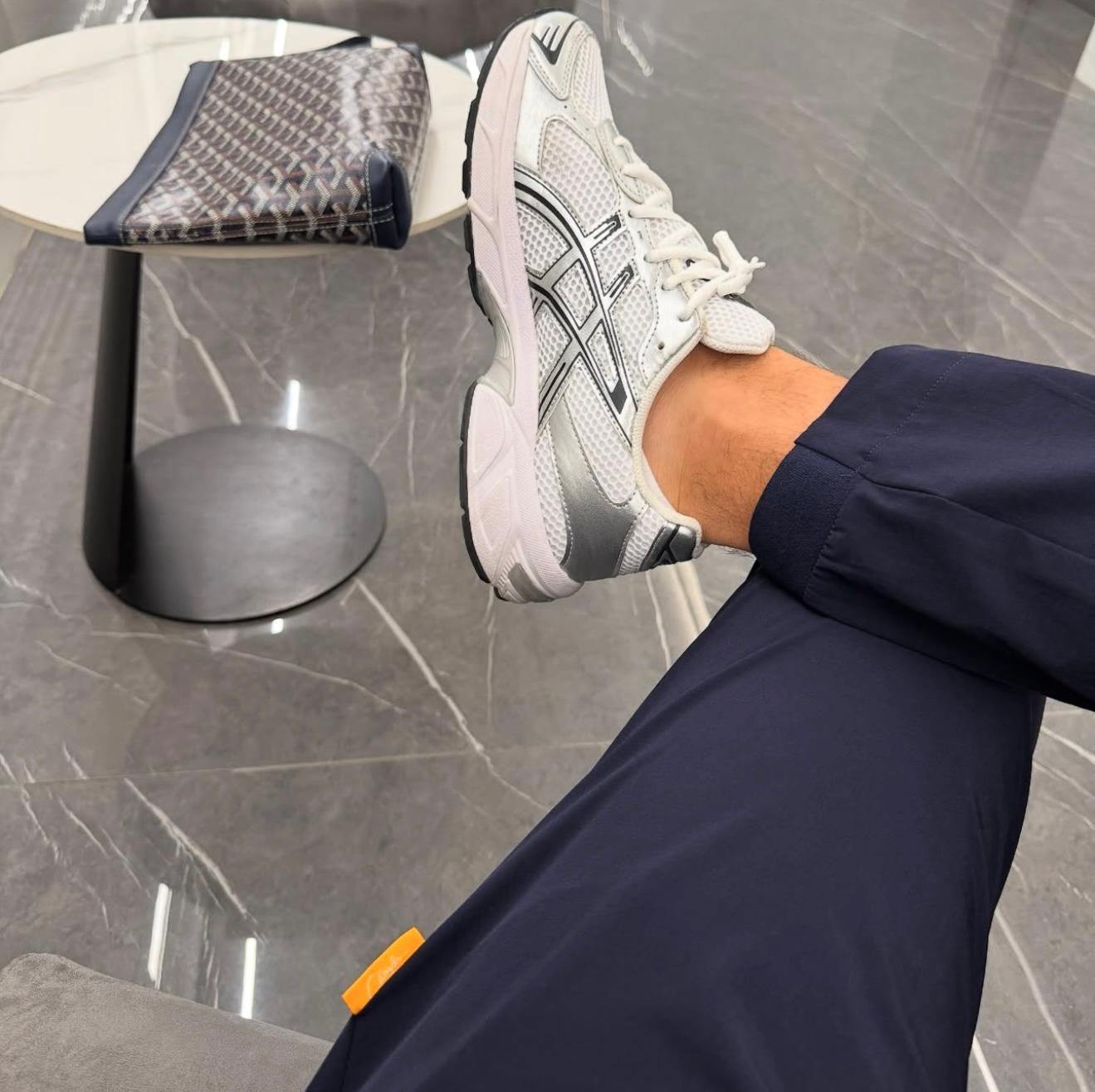 Studio By Charles navy trackpant worn with white and gray sneakers on tiled floor