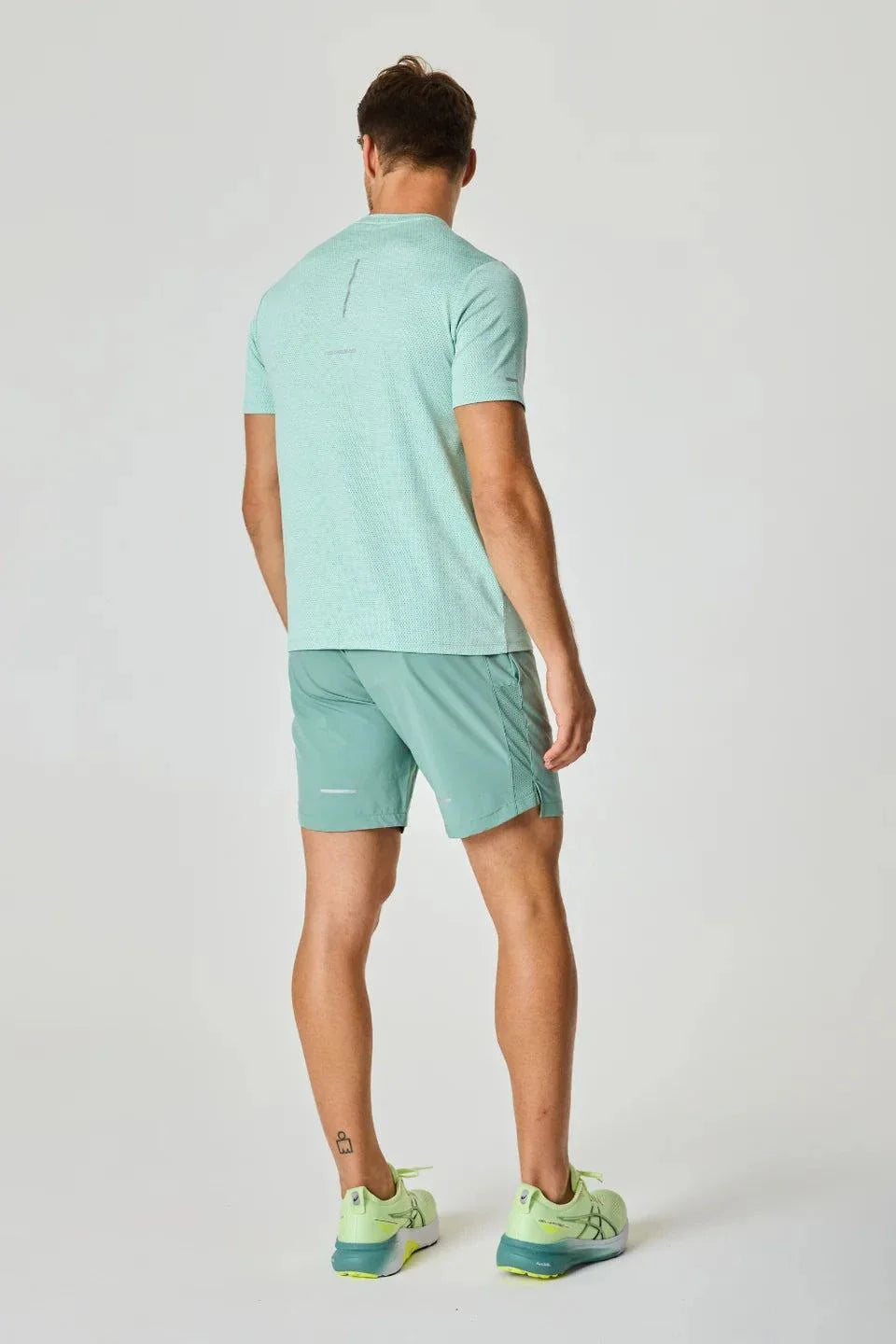 Reprimo Pulse T-Shirt in Seafoam color worn by a standing person.