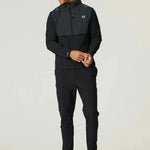 Man wearing black and volt Reprimo Summit windbreaker with hood and matching pants