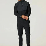 Man wearing black and volt Reprimo Summit windbreaker with hood and matching pants