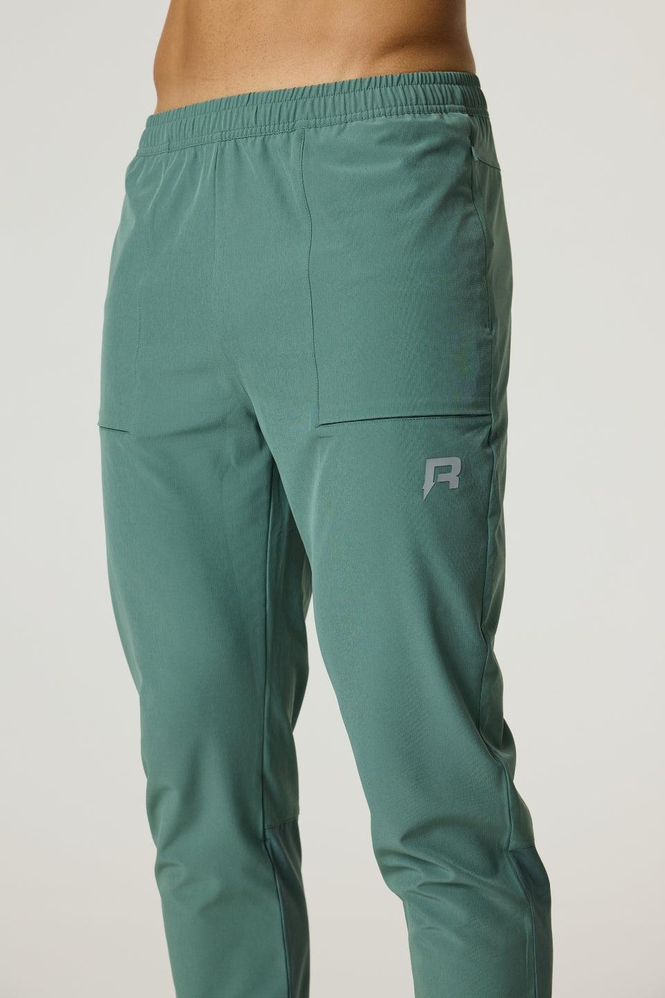 Men's Reprimo Glide Pants in botanical pine with tapered fit and secure seam-embedded pockets