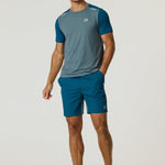 Athletic man wearing Reprimo Flight T-Shirt in tidal teal and blue steel with matching shorts and running shoes