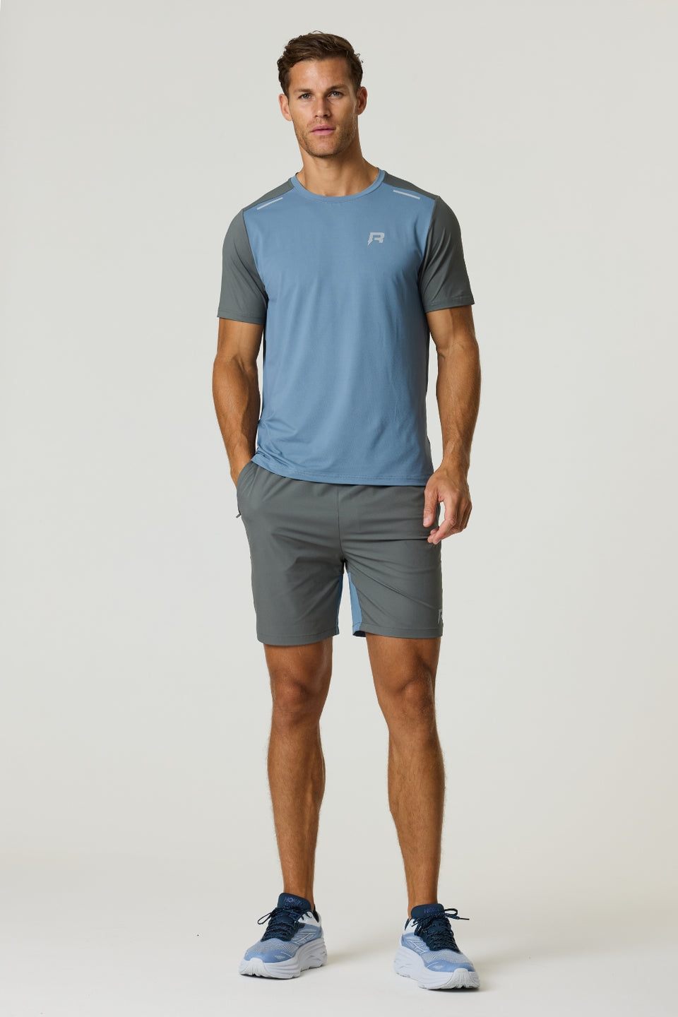 Reprimo Flight T-Shirt in Air Force Blue and Gunmetal with lightweight, breathable fabric and reflective strips for athletic performance and safety.