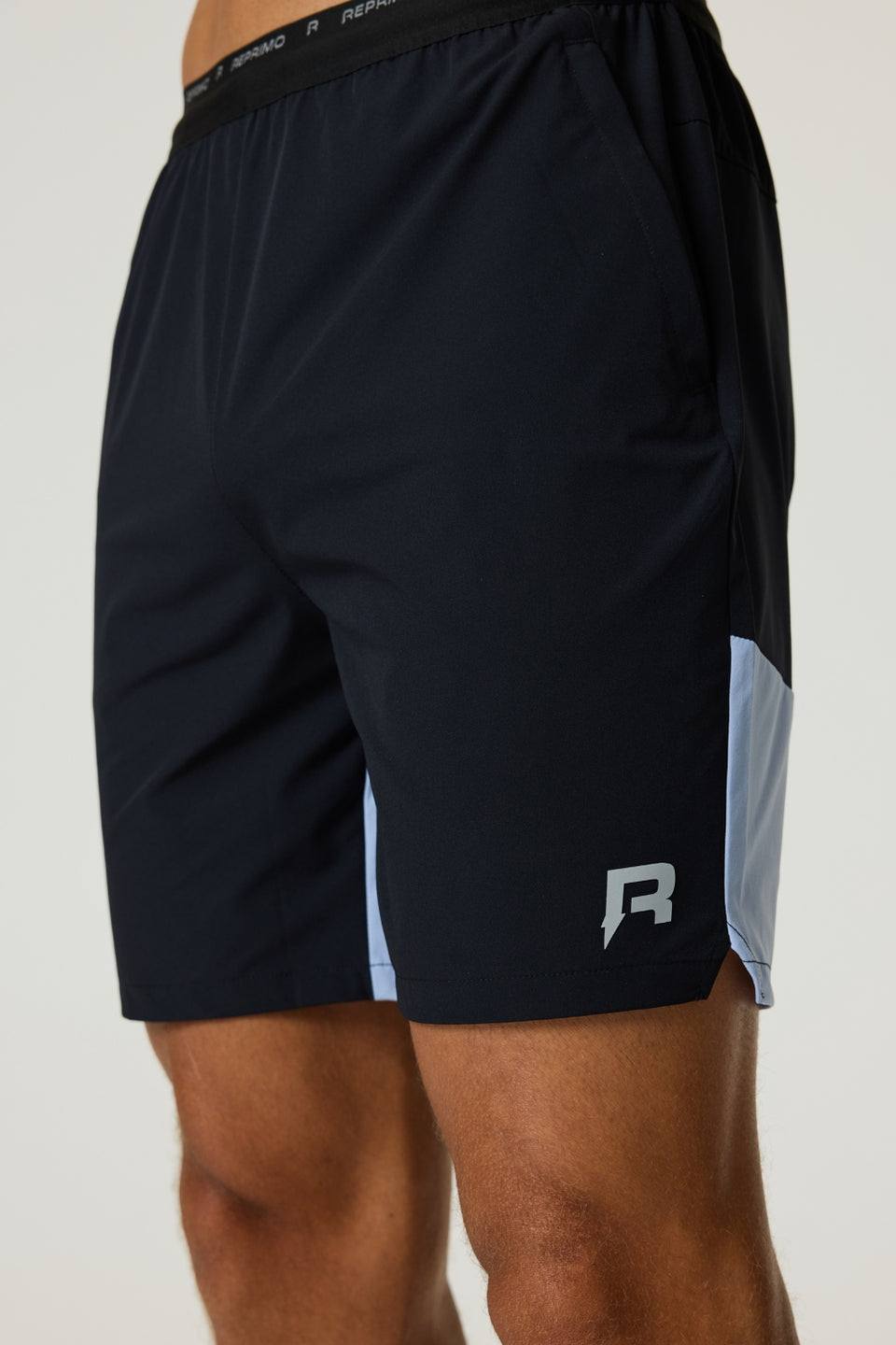 Black Reprimo Flight Shorts with dusky sky side panels, breathable lightweight fabric, elastic waistband, and functional zippered pockets.