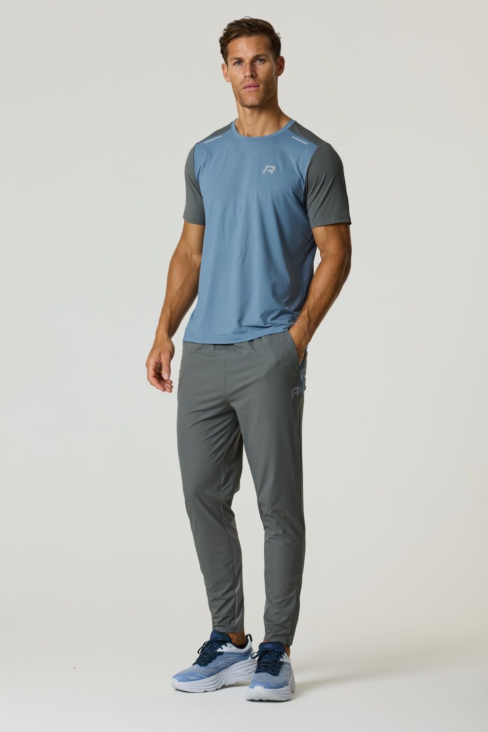 Man wearing Reprimo Flight Pants and matching athletic shirt in Air Force Blue and Gunmetal colors