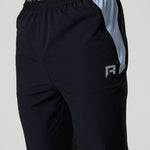 Black Reprimo Flight Pants with dusky sky side panels, elastic waistband, functional zippered pockets, and reflective strips for visibility.