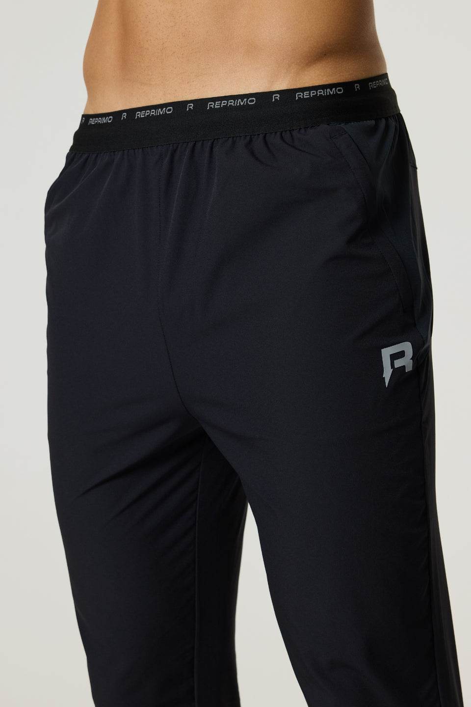 Black Reprimo Flight Pants with branded waistband and reflective logo for athletic performance and comfort