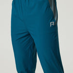 Men's Reprimo Flight Pants in tidal teal and blue steel with breathable fabric, reflective strips, and secure side pockets for active workouts.