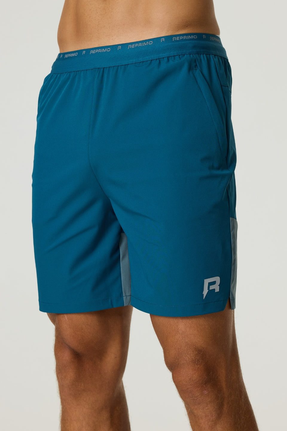 Men's Reprimo Flight Shorts in tidal teal with breathable fabric, elastic waistband, and secure zippered pockets for athletic performance.