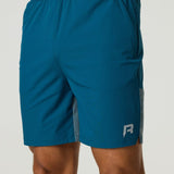 Men's Reprimo Flight Shorts in tidal teal with breathable fabric, elastic waistband, and secure zippered pockets for athletic performance.