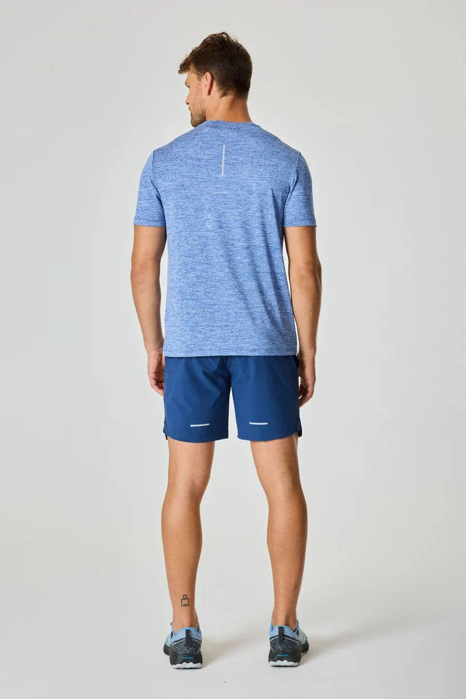 Reprimo Pulse T-Shirt in Indigo worn by male model, rear view.