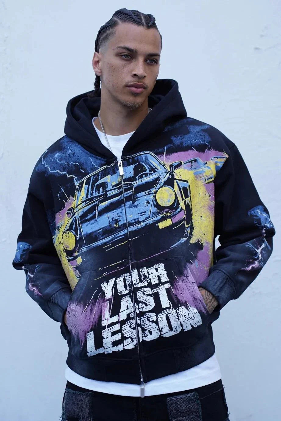 Last Lesson Black Car Hoodie with graphic vintage car design and bold text on front worn by male model