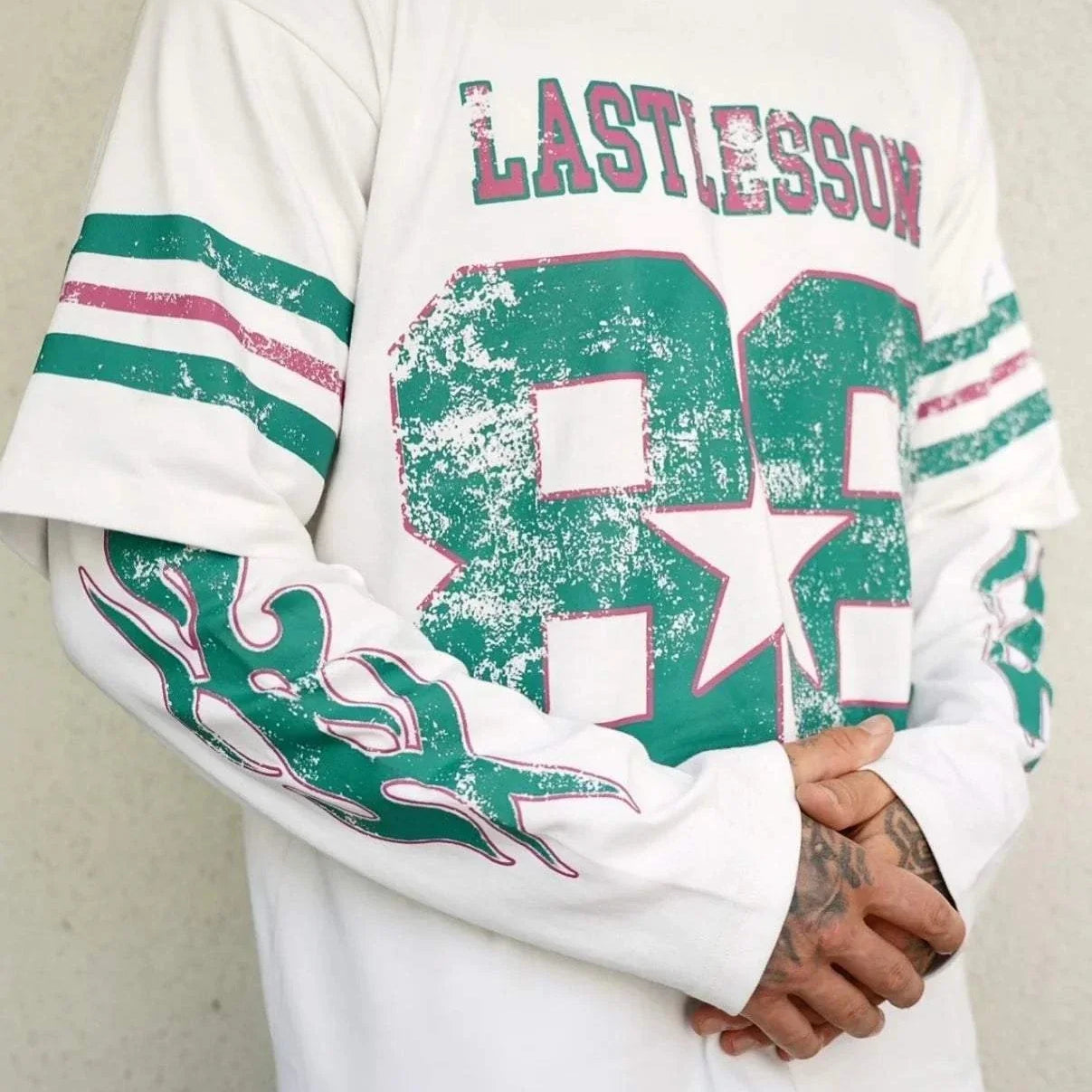 Last Lesson Double Sleeve Jersey with graphic design and stripes.