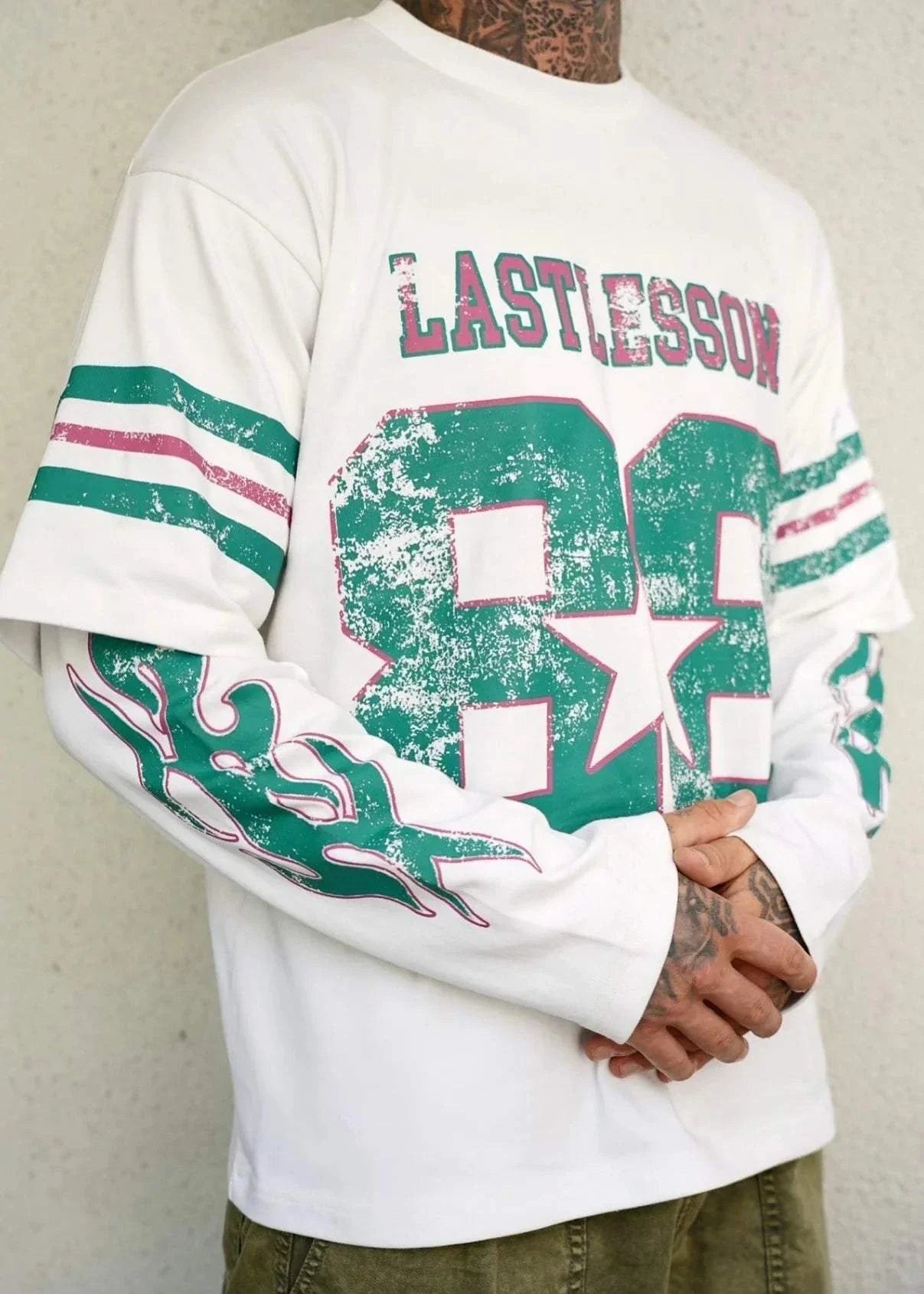 Last Lesson Double Sleeve Jersey with graphic design and stripes.
