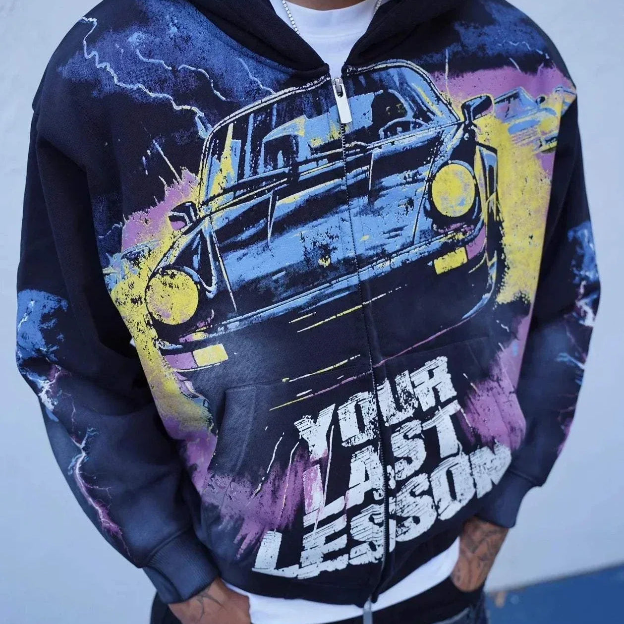 Last Lesson Black Car Hoodie with graphic car design and bold text worn by model
