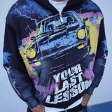 Last Lesson Black Car Hoodie with graphic car design and bold text worn by model