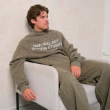 Green Natural Art Studio vintage wash sweatshirt with faded logo and oversized fit