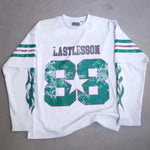 White Last Lesson Double Sleeve Jersey with green and red accents.