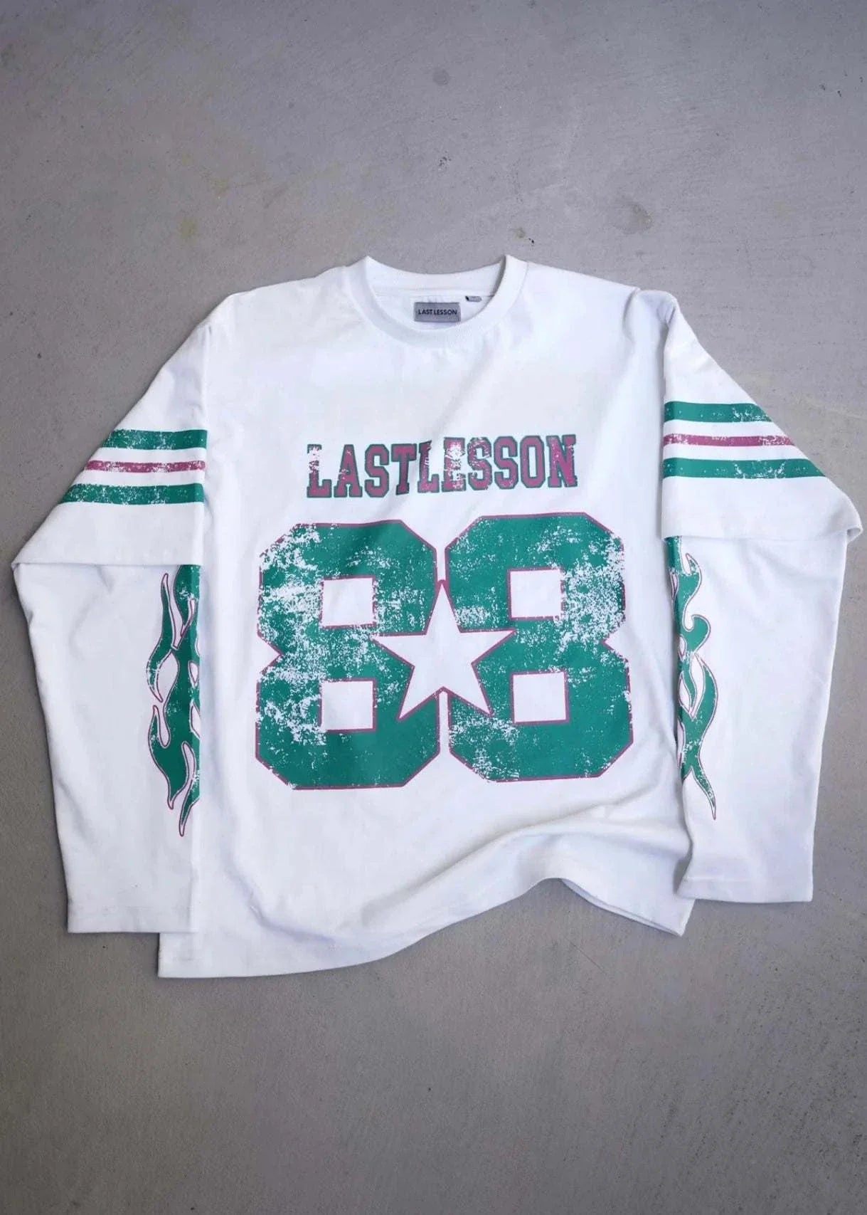 White Last Lesson Double Sleeve Jersey with green and red accents.