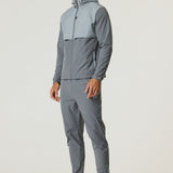 Athlete wearing Reprimo Summit Pant in slate and light grey with matching hoodie and sneakers